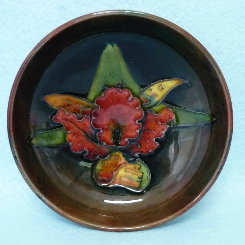 A Moorcroft Flambé Footed Bowl in the Orchid Pattern by Walter Moorcroft