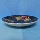 A Moorcroft Cup and Saucer in the Pansy Pattern by William Moorcroft
