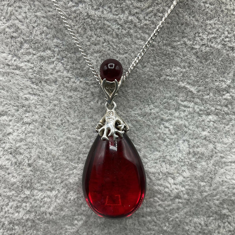 Silver and red amber pendant