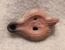 A Roman Redware Terracotta Oil Lamp With Lion Decoration.