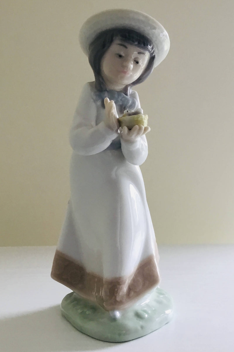 Nao by Lladro Girl Holding Birds Nest figurine