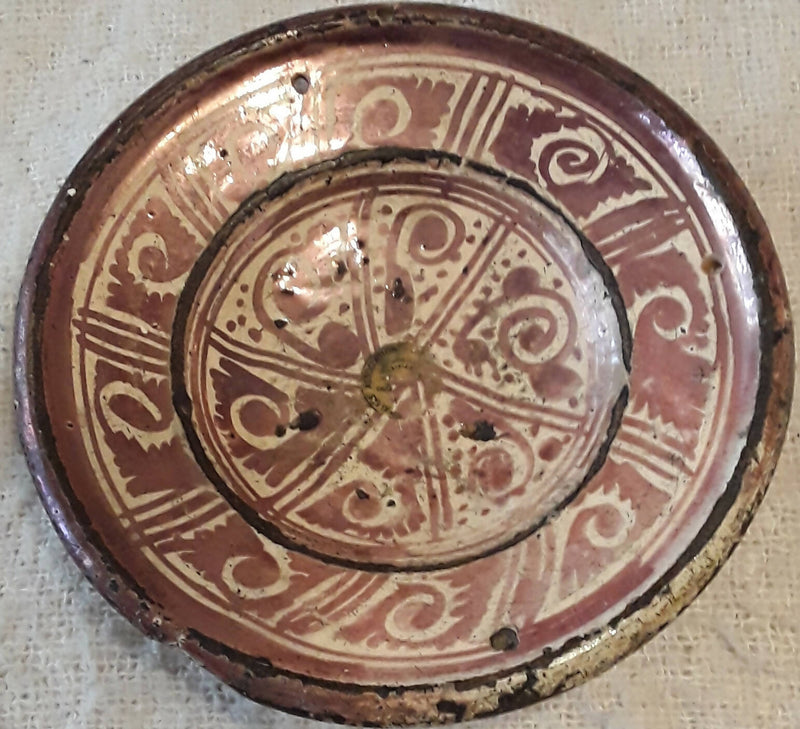 An Hispano - Moresque Terracotta Copper Lustre Glased Dish.