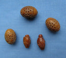 Two Figural Carved Nut Beads Plus Three Vegetable Ivory Beads