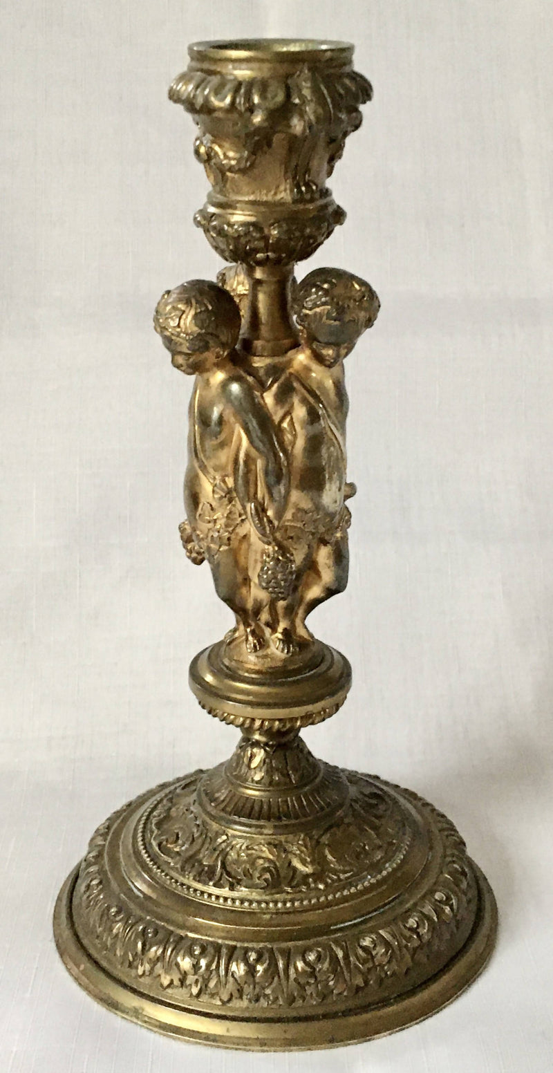Victorian gilt brass neo classical candlestick adorned with putti harvesting grapes.