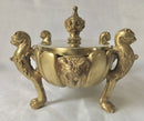 Regency period gilt bronze inkstand raised on lioness paw feet and adorned with ram masks.