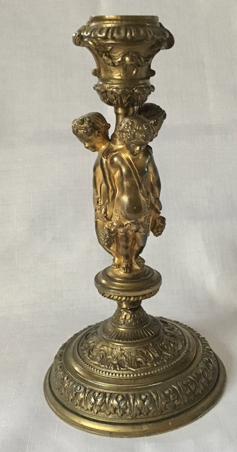 Victorian gilt brass neo classical candlestick adorned with putti harvesting grapes.