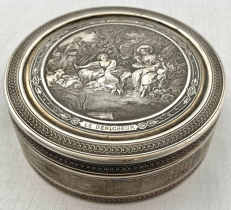 Edwardian Circular Silver Box. Engraved with Le Denicheur, after Boucher. London 1910 Andrew Barrett & Sons. 6.7 troy ounces.