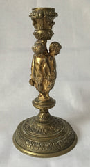 Victorian gilt brass neo classical candlestick adorned with putti harvesting grapes.