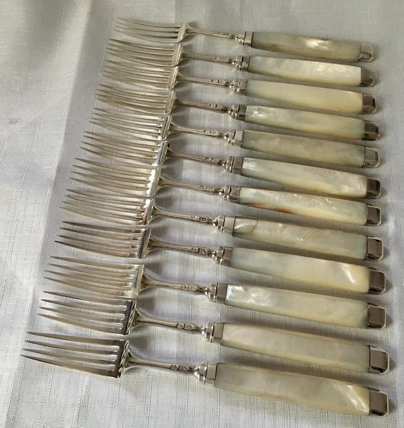 Georgian, George III, silver and mother of pearl dessert knives and forks for twelve, circa 1810.