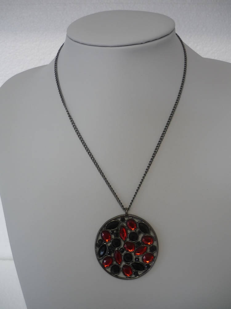 A Vintage Style Necklace with Oval and Round stones in a Circular Setting.