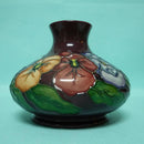 A Moorcroft Squat Vase (Dia 5.23") in the Pansy Design by Rachel Bishop