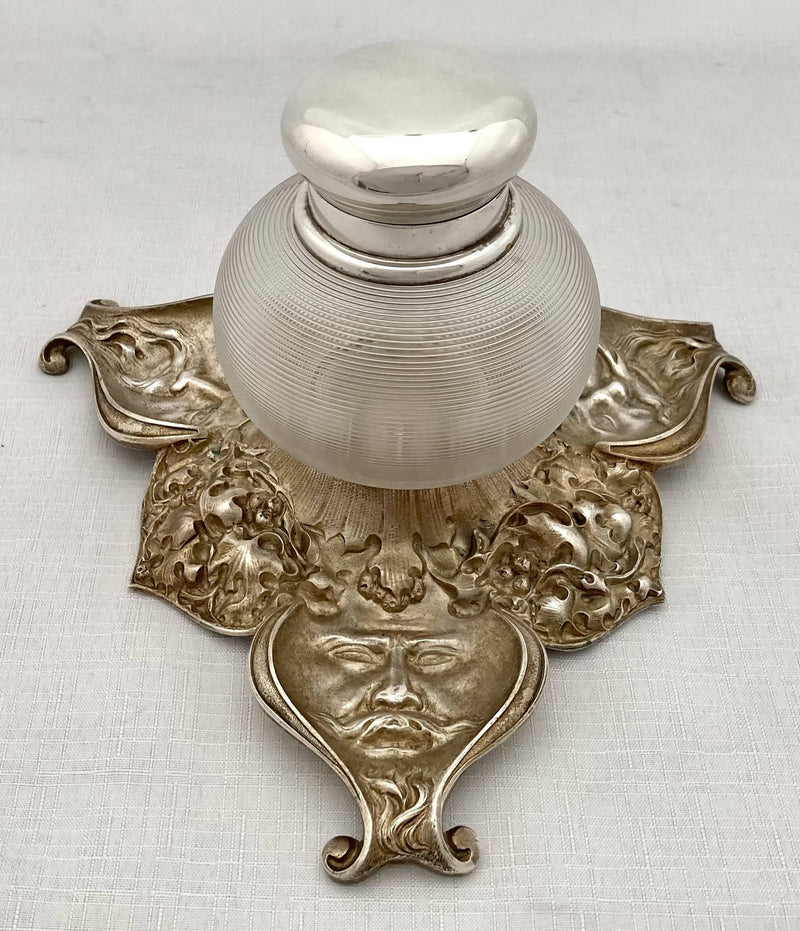 Victorian silver plated inkstand of trefoil form adorned with facial profiles. Elkington 1857 for The Art Manufacturers Association.