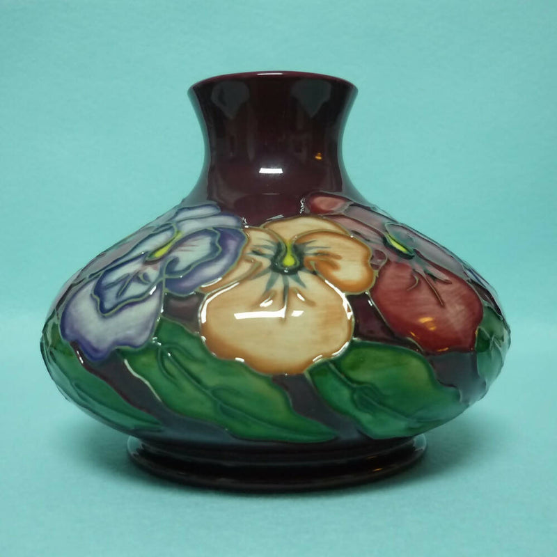 A Moorcroft Squat Vase (Dia 5.23") in the Pansy Design by Rachel Bishop