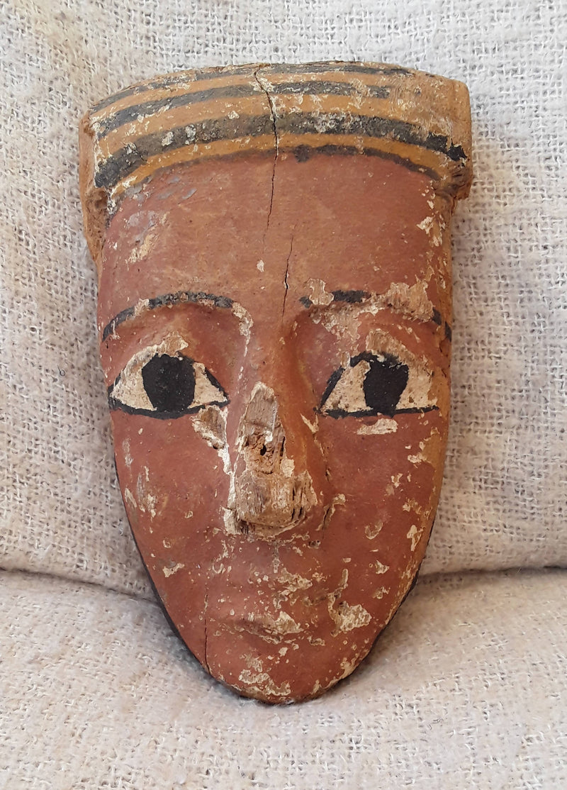 An Ancient Egyptian Wooden Gesso Painted Mummy Mask.