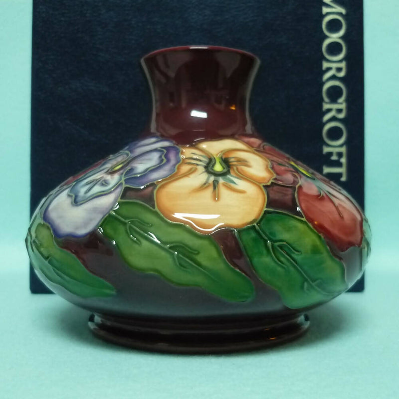 A Moorcroft Squat Vase (Dia 5.23") in the Pansy Design by Rachel Bishop
