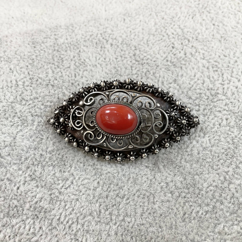 Silver and red coral brooch