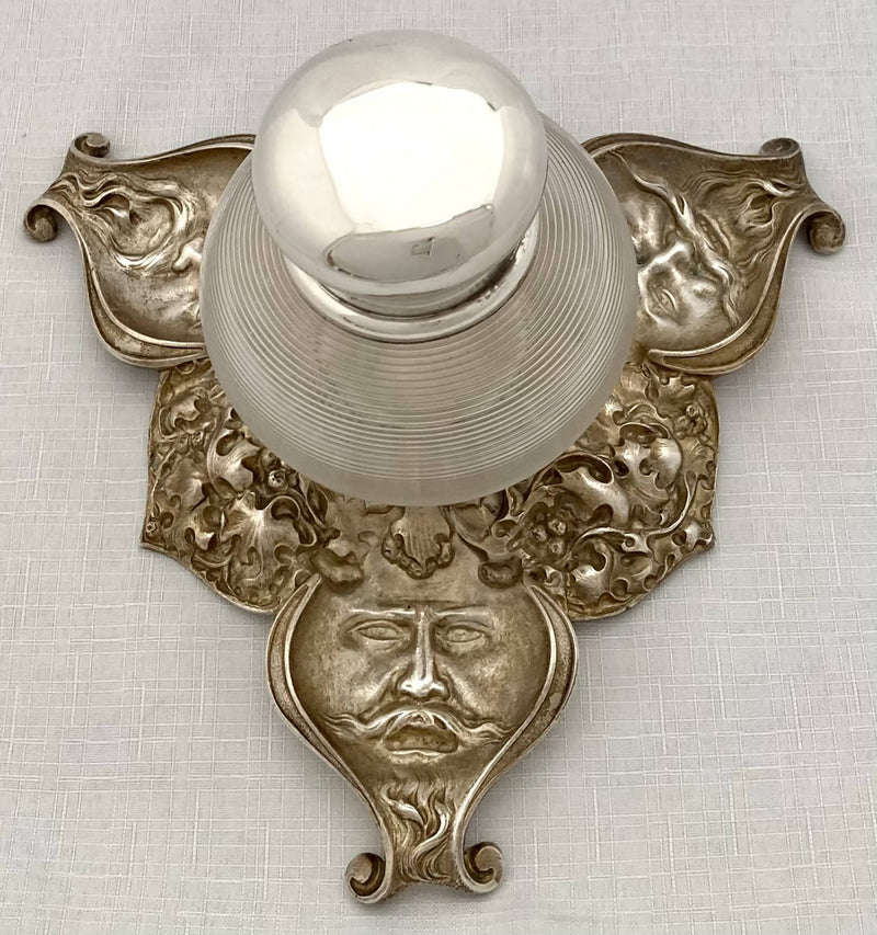 Victorian silver plated inkstand of trefoil form adorned with facial profiles. Elkington 1857 for The Art Manufacturers Association.