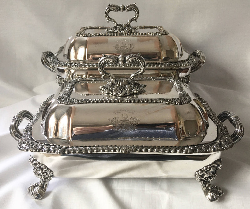 Late Georgian pair of Old Sheffield Plated, crested, entree dishes and covers on warming stands. Circa 1820.