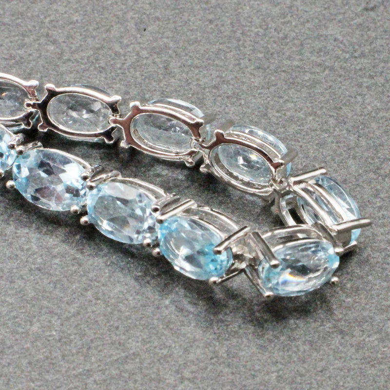 Silver blue topaz set line bracelet