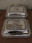 Pair of late Georgian Old Sheffield Plate crested entree dishes with covers and detachable handles.