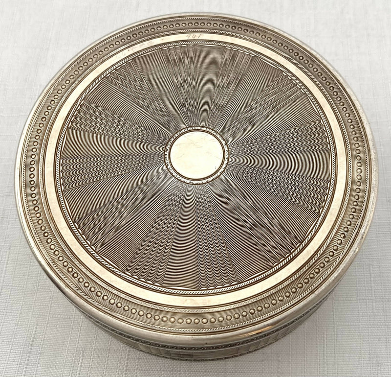 Edwardian Circular Silver Box. Engraved with Le Denicheur, after Boucher. London 1910 Andrew Barrett & Sons. 6.7 troy ounces.